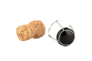 Selective focus. Separated champagne cork and wire isolated on white background.