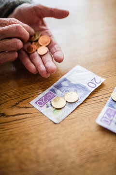Hands holding banknotes and coins, Sweden