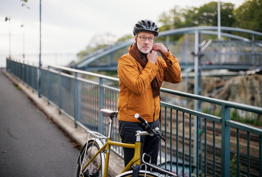 Mature Man Putting Cycling Helmet On, Sweden