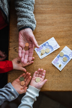 Hands holding coins, Sweden