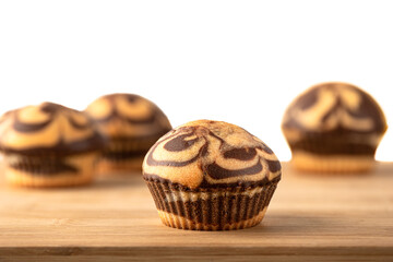 Selective focus of close-ups of muffins on a wooden background.