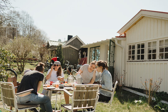 Family having meal in garden, Sweden