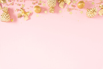 Christmas gold holiday composition. Xmas golden decorations on pink background. Christmas, New Year, winter concept. Flat lay, top view, copy space