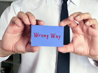  Motivational concept about  Wrong Way    with phrase on the piece of paper.
