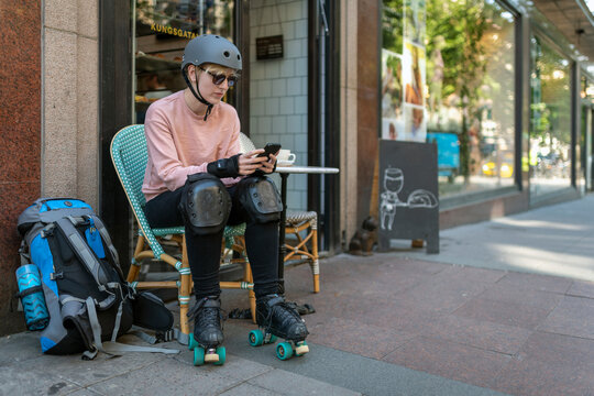 Female skater in outdoor cafe, Sweden