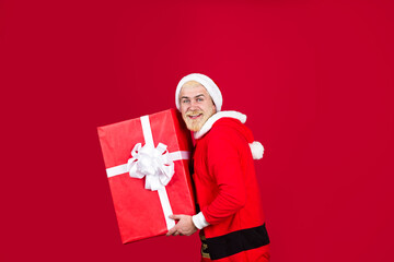 Christmas Santa. Delivery gifts. New year gift. Christmas decorations. Santa Claus hold big present. New year gift. Present box.