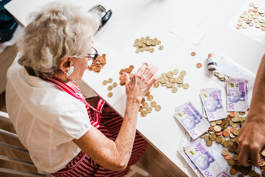 Woman counting coins, Sweden