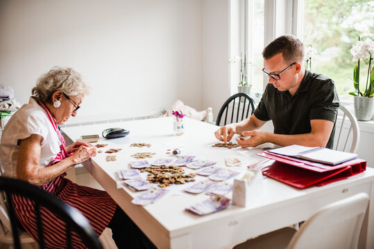 Man and woman counting coins, Sweden