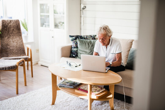 Woman using laptop, Sweden