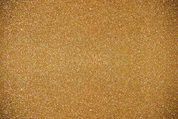 Glitter dark yellow background. Photo of monotone shiny background.