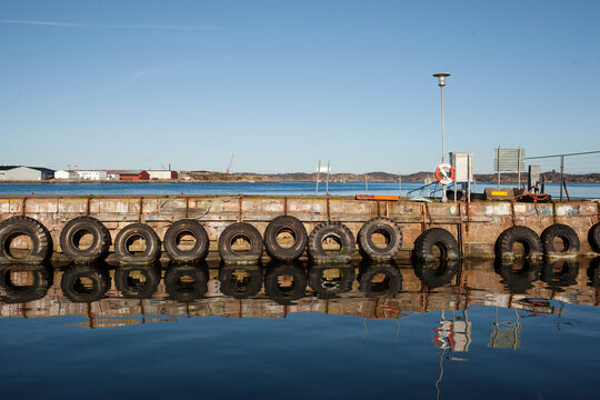 Tires hanging on jetty, Sweden