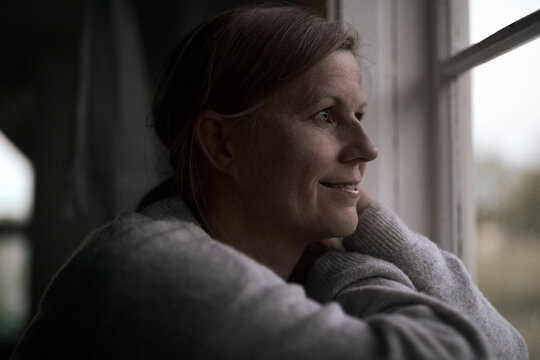 Woman looking through window, Sweden