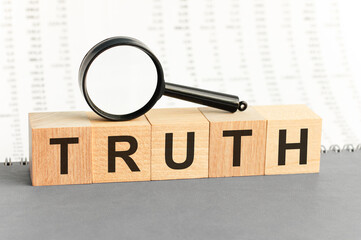 Wooden Blocks with the text: truth with magnifying glass.