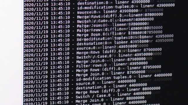 White computer software code moving on a black monitor. Computer hacking in process, dynamic text running and flowing on pc screen.