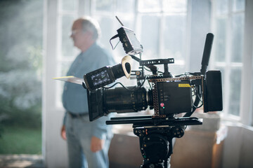 Professional film and video camera on the set. Shooting shift, equipment and group.