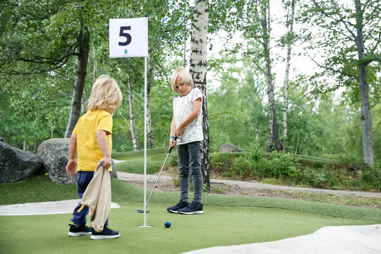 Boys playing mini golf, Sweden