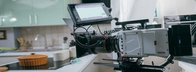 Professional film and video camera on the set. Shooting shift, equipment and group.