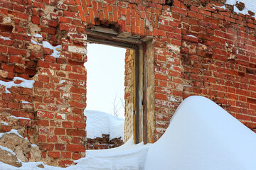 Ruins of old brick wall with window hole