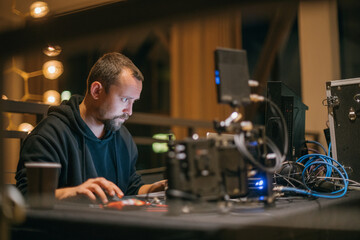 Editing director behind monitors on the set.