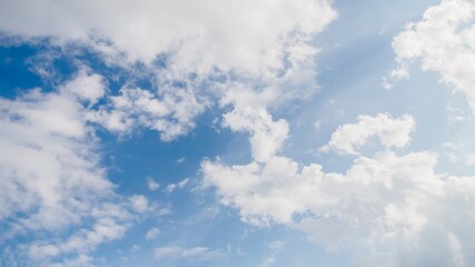 Light blue sky with natural white fluffy clouds