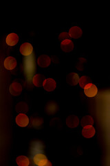 Multicolored colorful bokeh lights on abstract dark background. Vertical photo