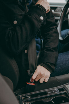 Person fastening seat belt in car, Sweden