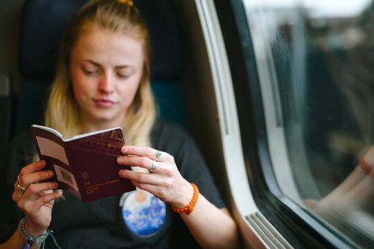 Woman Holding Passport In Train, Switzerland