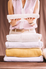 Fototapeta na wymiar Close up of folded stack of light colored towels