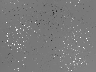 Confetti stars sparkling on a grey background.