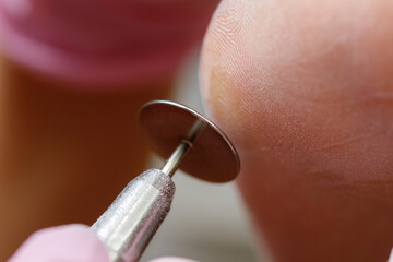 Professional hardware pedicure using electric machine. Patient on medical pedicure procedure with...