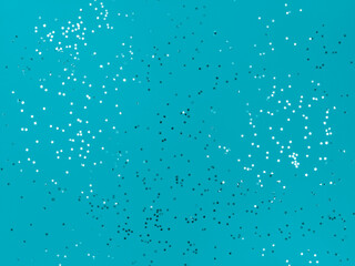 Confetti stars sparkling on a blue background.
