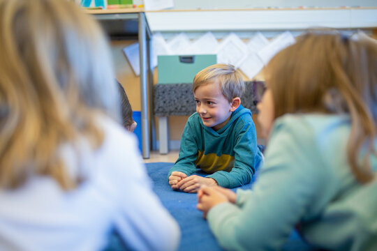 Boy in classroom lying on floor, Sweden