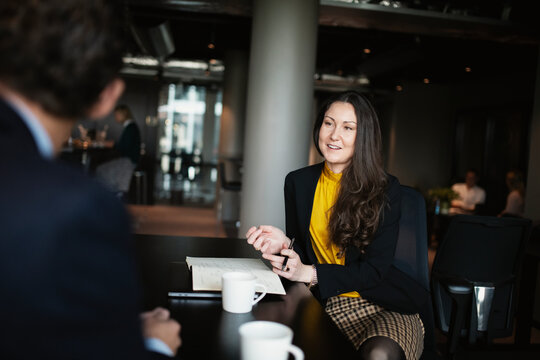 Smiling businesswoman talking in restaurant, Sweden