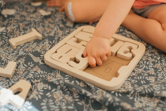 Child solving wooden puzzles, Sweden