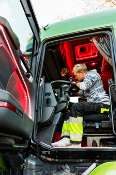 Lorry driver in vehicle cabin, Sweden