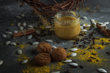 A jar of honey, cookies and spices