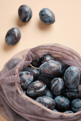 Natural Organic Plums in Shopping Net Bag. Fresh Tasty Ripe Fruit Food. Sweet Vitamin Delicious Nutrition Product Ingredient for Raw Food Eater. Zero waste