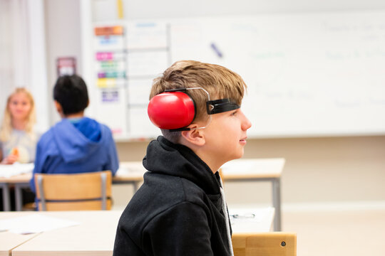 Boy wearing ear protectors, Sweden
