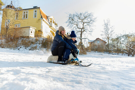 Mother with son sledging, Sweden