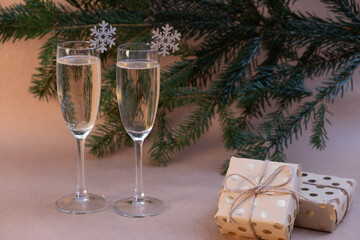 two glasses of champagne and gifts lie on the New Year's table