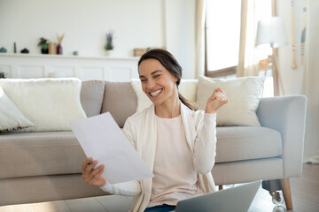 Yes. Overjoyed young woman remote employee reading paper letter from company informing she is hired on vacant place, happy millennial lady bank client getting loan mortgage credit application approval - obrazy, fototapety, plakaty