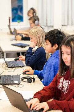 Children in classroom using laptops, Sweden