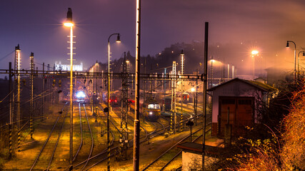Bridge view of train depot with trains, misty evening