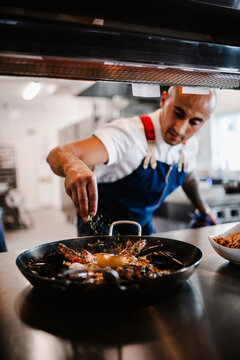 Chef preparing paella, Sweden
