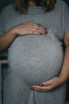Pregnant woman with hands on belly, Sweden