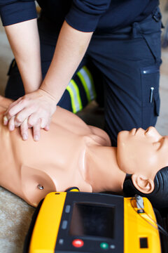 Midsection of paramedic performing cpr on mannequin, Sweden