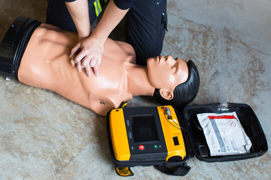 Midsection of paramedic performing cpr on mannequin, Sweden
