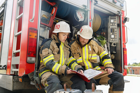 Firefighters studying documents, Sweden