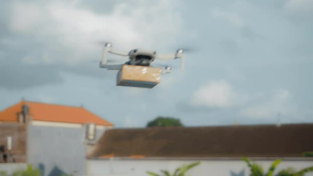 flying on a sky delivery drone with holding a .cardboard parcel