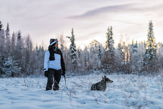 Woman walking dog at winter, Sweden